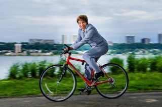 Bicycle rider in business suit along Hudson River