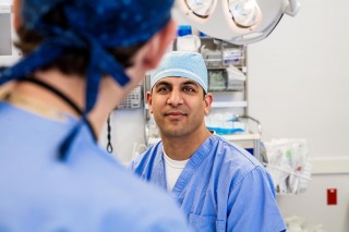Surgeons in scrubs discussing upcoming surgery