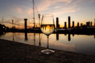 Wine glass on NYC pier at sunset